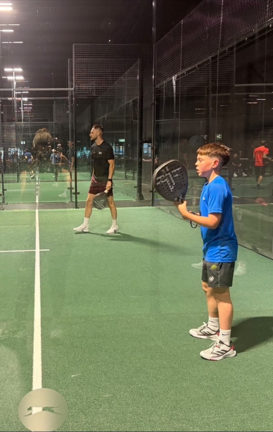 Marcus coaching a junior player during a padel session